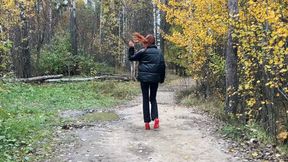 A girl in high-heeled shoes fell and sprained her ankle, she has a difficult path through mountains and potholes