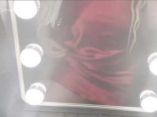 Golden-haired in front of mirror in a red evening suit in advance of going out!