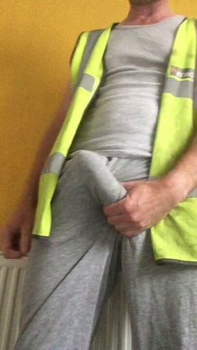 Tradesman uses hi vis vest as cumrag