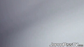 Delectable Japanese beauty is peeing outside during day time