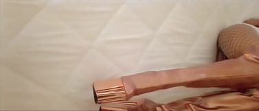 Gold knee high boots, fishnet stockings, micro skirt and a white mini top