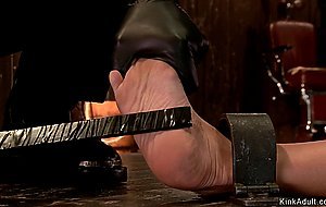 Strapped brunette slave gets fingered