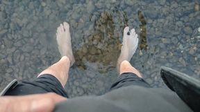 Sweaty, filthy and smelly feet in the river