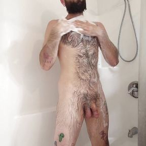 hairy guy spnds taking a shower and gets wet