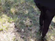Walking on the wood wearing a black dress, pantyhose and high heels ankle boots