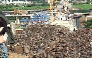 A cute blonde girl is fucked by 2 guys at a construction site