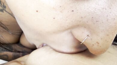Her split tongue slides over her pierced nipples