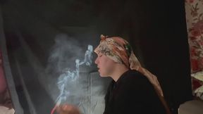 YULIANA LIGHTS HER CIGARETTE WHILE WEARING A HEAD SCARF