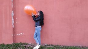 Playing with a red balloon outdoors - Mishel Looner Balloons