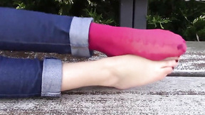 Warm stunning sexy girl Diana rests on a bench in a really jampacked park, with her pink socks on. She chooses to