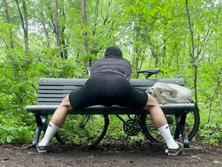 Biker In Spandex Stretching At The Park