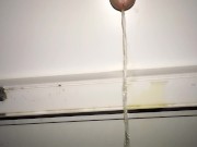 Teen piss out of a window in a entrance of apartment building - Rainy night