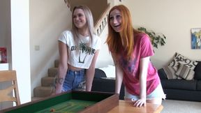 A couple of sexy skinny girls playing a strip craps game with their friend