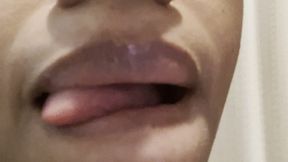 Sticking out Long Tongue and licking Glossy Lips