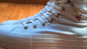 My girlfriend crushes my hand with her white Converse.