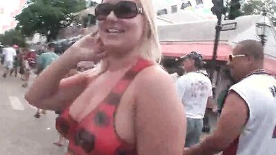 Topless amateur women have their tits covered in body paint for a summer parade