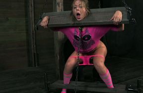 White skank Chastity Lynn is fixed in the pillory and teased