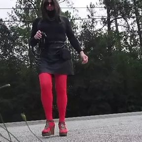 Crossdress walk outdoors by traffic.