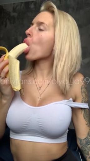 Sexy blonde with huge breasts seduced and eats a banana