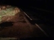 Fishnet stockings in road . Passing car
