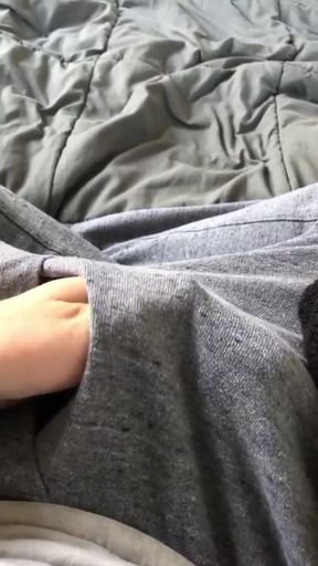 Throbbing uncut cock bounces out of gray sweatpants