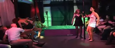 Neon-lit club filled with horny older women deep-throating big cocks.