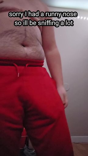 Chubby guy jerking off with blue condom while standing
