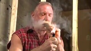 Scott Reynolds smokes a cigar while playing with his cock