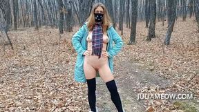 Exhibitionist girl undresses in the autumn forest