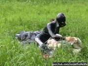 Rubber girl full in black latex catsuit and mask plays with herself outdoor in a meadow - Part 1
