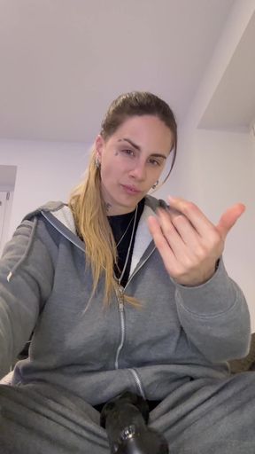 Woman in grey sweatpants holding a phone