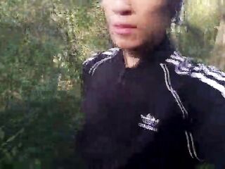 Who will spot this twink in a ebony-and-white Adidas tracksuit, flashing his dong in public—going commando—and peeing into the river?