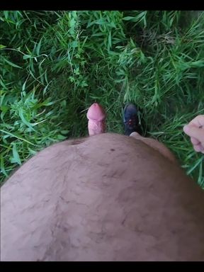 Naked outside under a bridge.
