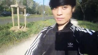 Freeballing in public, this lad ambles outdoors commando, no undergarments underneath his black Adidas tracksuit, Campus sneakers, while out cruising