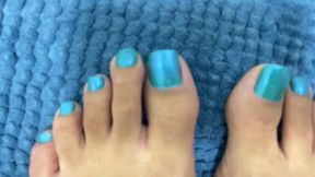 beautiful feet with bright blue toenails
