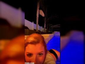 sexy blonde girl shows her tits in the pool