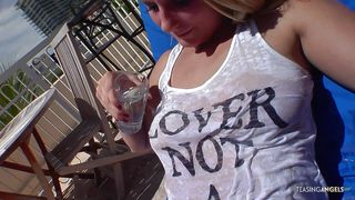 Tanning on the balcony has left the blonde wet and horny for a big cock