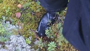 Wet rubber boots walking in forrest