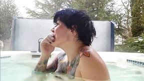 Tattooed brunette girl showing her pussy in the pool