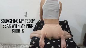 Squashing my teddy bear with my pink shorts