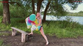 Alla releases all the air from an inflatable seal with a loud hiss on the shore of a lake.