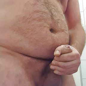 Daddy Bear jerks his fat uncut cock on public toilet with thick cumshot