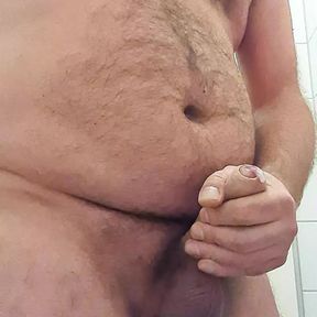 Daddy Bear jerks his fat uncut cock on public toilet with thick cumshot