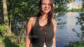 a girl with big tits sucks a cock and swallows cum in a public park