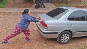 Jessie is trying to move and lift the broken-down car