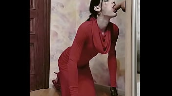Crossdresser in elegant dress sucks big dildo