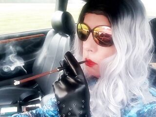 OLDER LIKES TO DRIVE AND SMOKE HER LENGTHY CIGARETTES