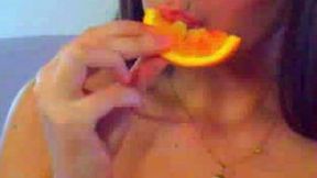 Frisky brown haired cutie rubs her goodies with orange for me
