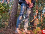 Guy long pissing in the forest under a tree
