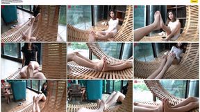 Two beautiful women, Yi Yi and Yao Zi, sat by the restaurant window, playfully interacting with each other's beautiful feet.